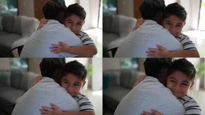Son embracing his father at home