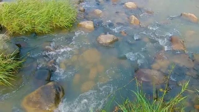 flowing water streams of river with isolate iron s