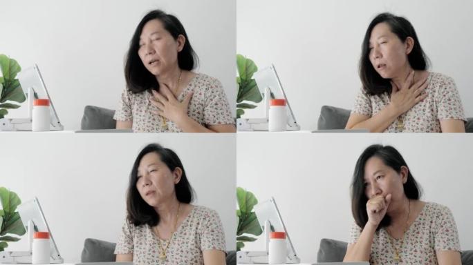 亚洲成年女性在家中通过数字平板电脑向医生打视频电话，询问自己的健康状况，这是社交疏远的生活方式概念。