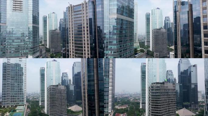 雅加达-印度尼西亚。2022年5月20日: 在现代城市市区的玻璃摩天大楼之间飞行
