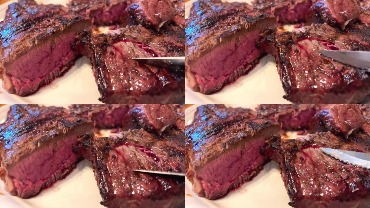 盘子上有带血的肉它是用刀在烧烤架上炸的牛肉，摸摸它，肉红，非常开胃和多汁，它让你想吃它，肉切成薄片，