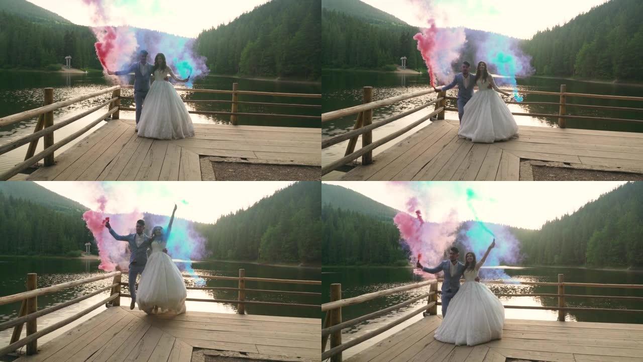 婚礼情侣在湖山上一起旋转彩烟。慢动作