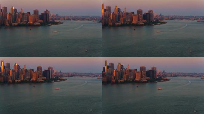 Boats sailing along the Hudson River at sunset wit