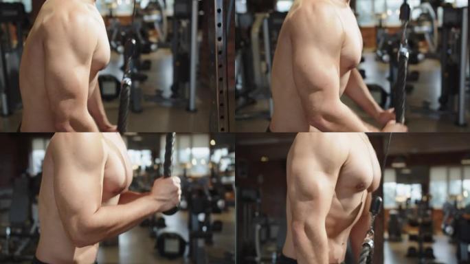 健身男子在健身房锻炼肌肉。裸露的躯干。强壮的运动帅哥
