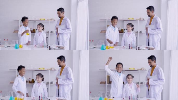 4K，在学校的科学实验室中，学生由老师教，女孩和男孩通过拍手并在老师的称赞后跳起来表现出喜悦。概念教