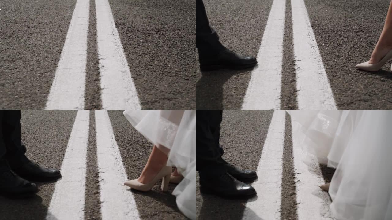 穿着黑色鞋子的男人，穿着衣服的女人在路上接近双实线，特写。