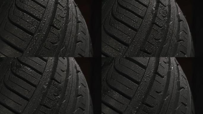 黑色背景上的湿轮胎胎面