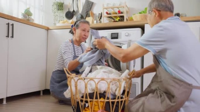 亚洲高级夫妇在家做家务和家务。活跃的老年成熟祖父母清洁并将衣服放在洗衣机中洗衣服，一起享受退休生活。