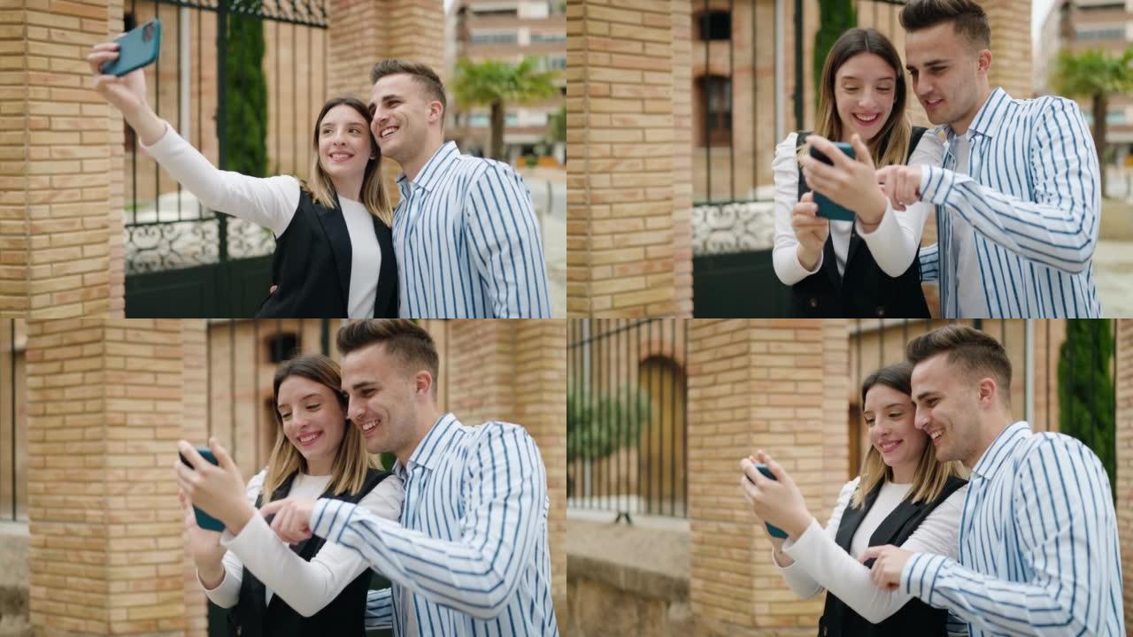 男女情侣互相拥抱，在街上用智能手机自拍