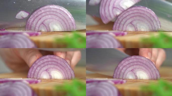 宏观拍摄手在厨房蔬菜背景的砧板上切新鲜的红洋葱。剁碎。
