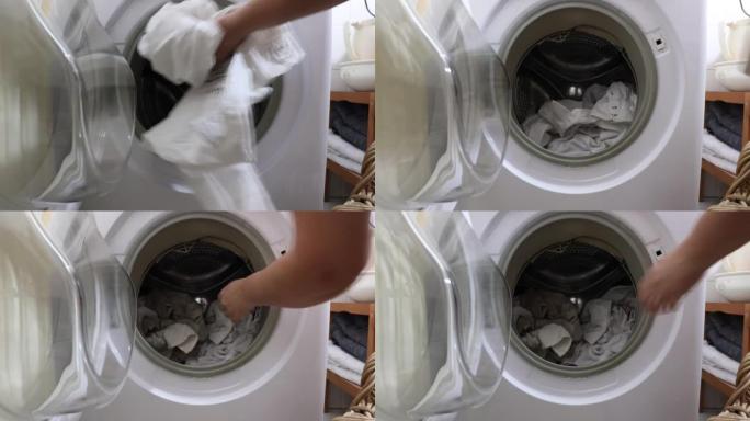 女性的手将脏衣服与要洗的洗涤剂一起放入洗衣机