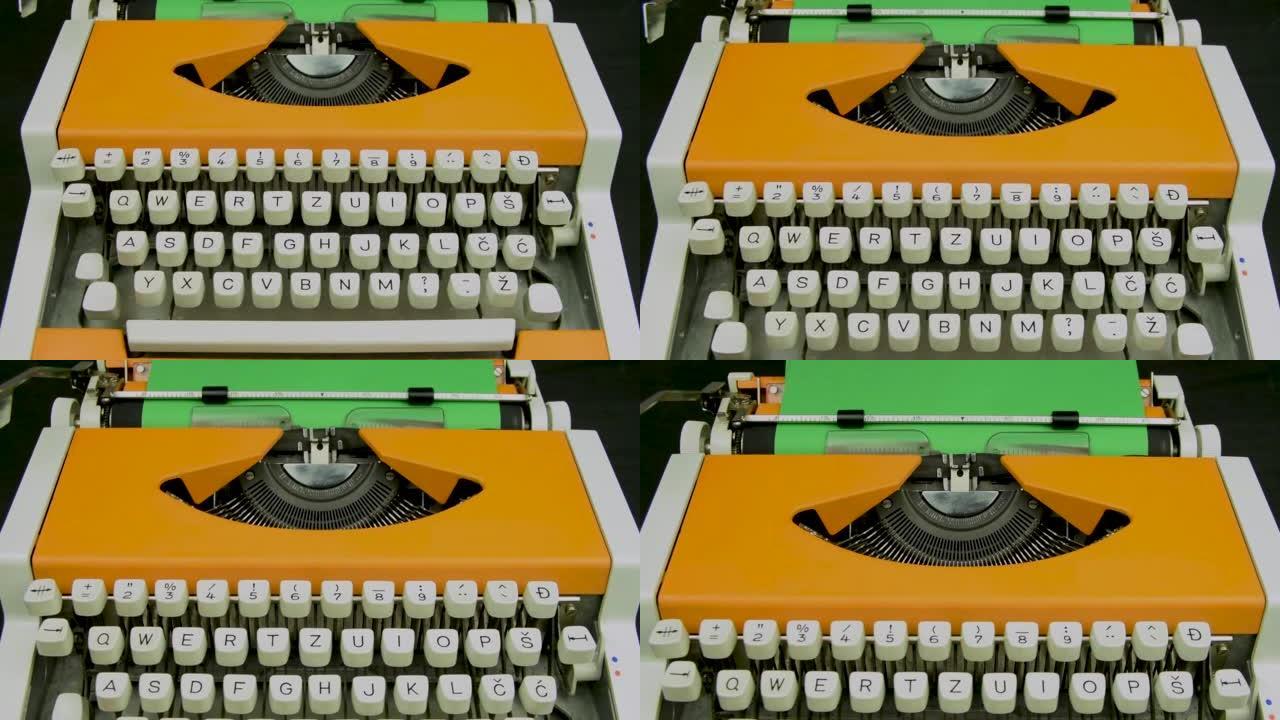 打字机时尚橙色。老式机械打字机。白色键盘绿纸。