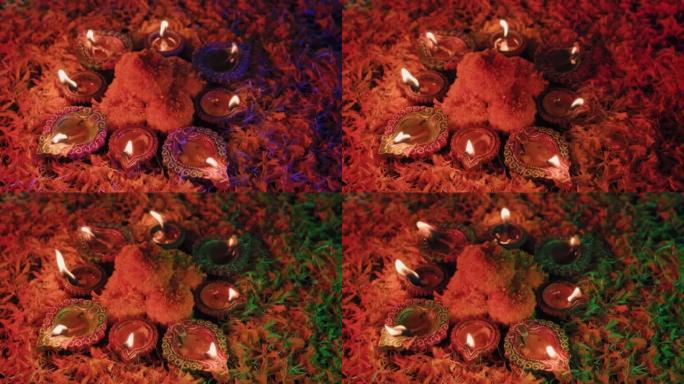 五颜六色的排灯节油灯，屠妖节油灯以美丽的形式点亮，中间有花朵，在五颜六色的背景下有不同的五颜六色的花