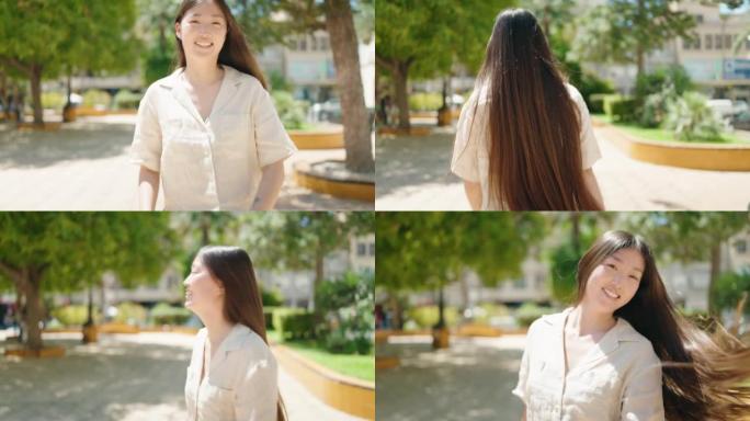 中国女人微笑着自信地走路，在公园里自首