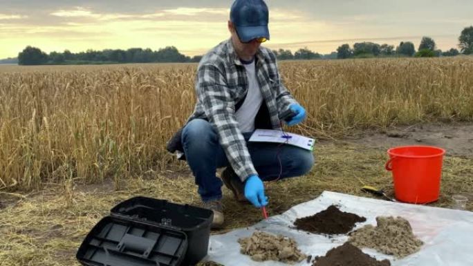 农学家利用数字室外土壤测试仪准备测量