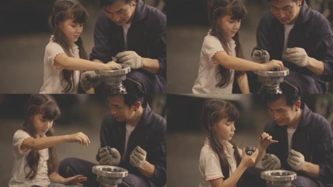 女儿协助父亲修理汽车。