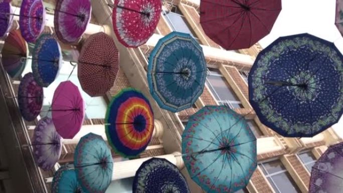 Colorful umbrellas hanging in the sky