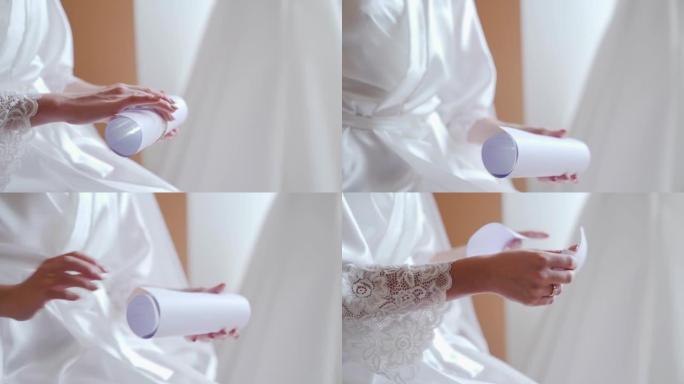 穿着白色连衣裙的新娘用誓言打开复古笔记本。特写，慢动作。
