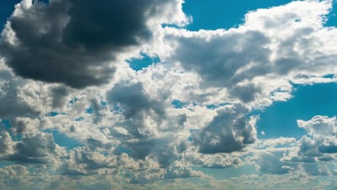 White Fluffy Clouds Slowly Float Through the Blue 