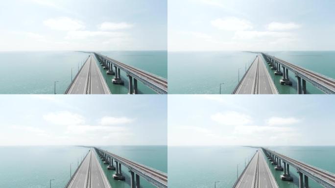 跨海的长桥公路俯视图。行动。美丽的风景，绿松石海上有铰接的白色桥。晴天与公路跨海大桥