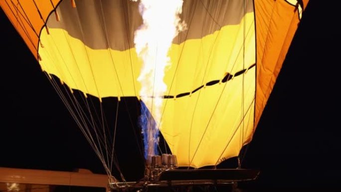 At night, the flame fills the balloon with air, cl