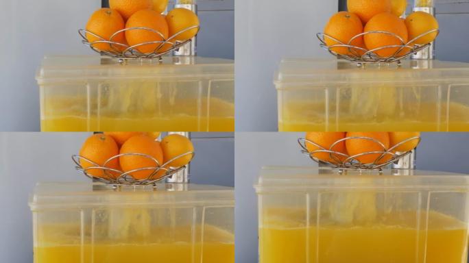 一个装满柑橘汁的塑料容器在橙汁喷泉中冒出了一半。慢动作，橙色。清新健康的柑橘