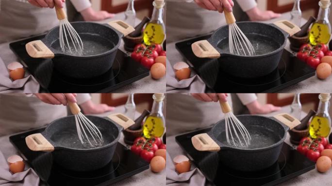 煮鸡蛋-女人在锅里用盐和醋搅打开水