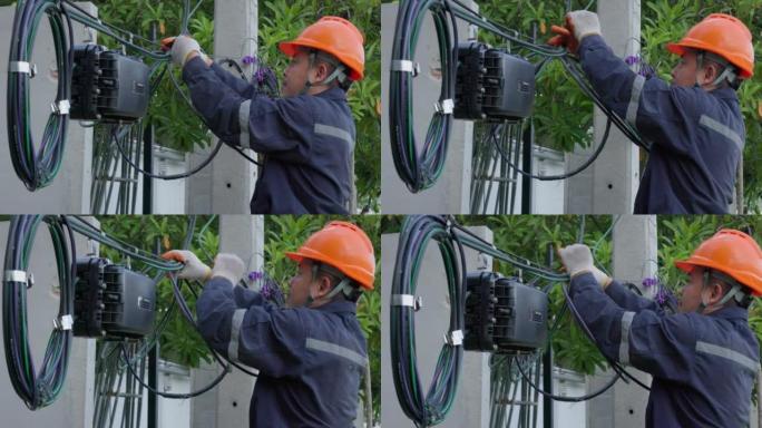 互联网技术人员正在通过打开光纤连接器来修复或维护光纤连接。