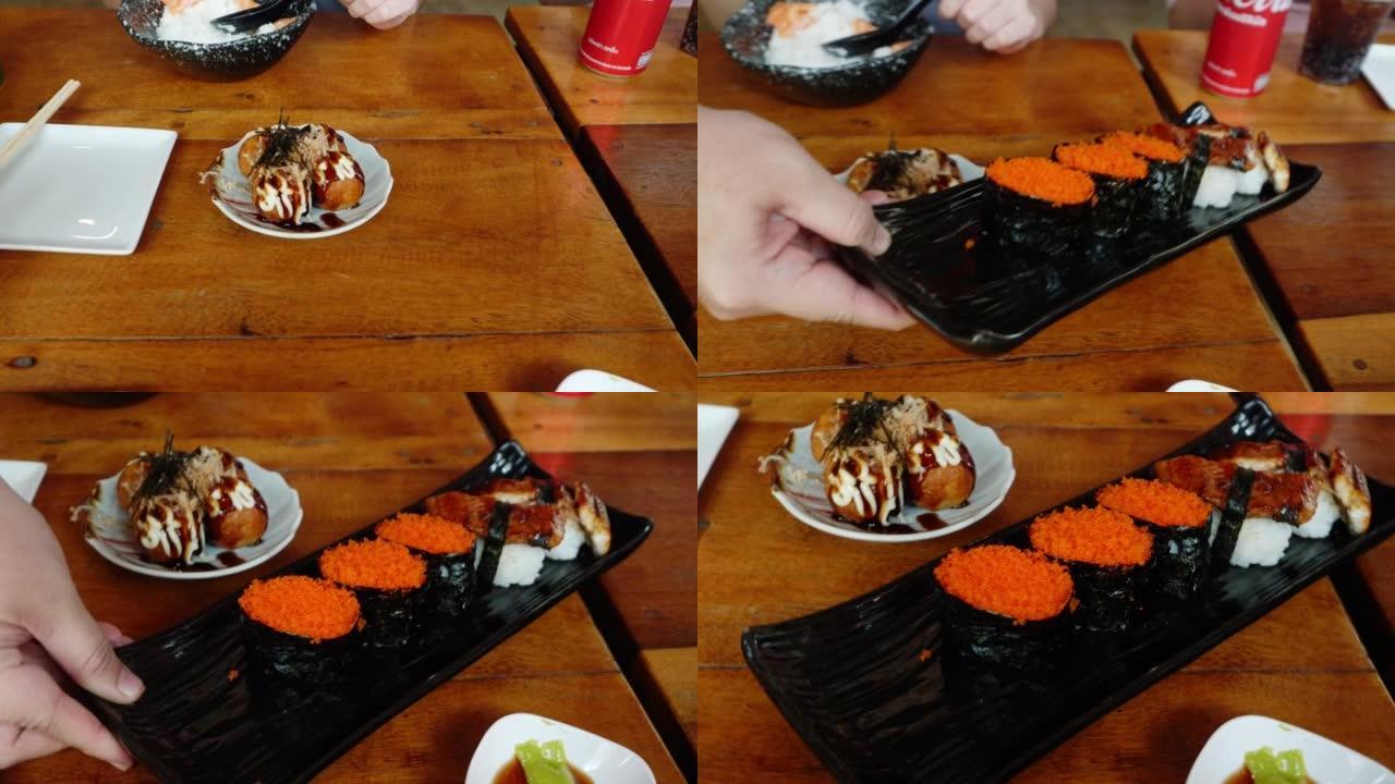 日本餐厅的餐桌上供应寿司和章鱼烧。