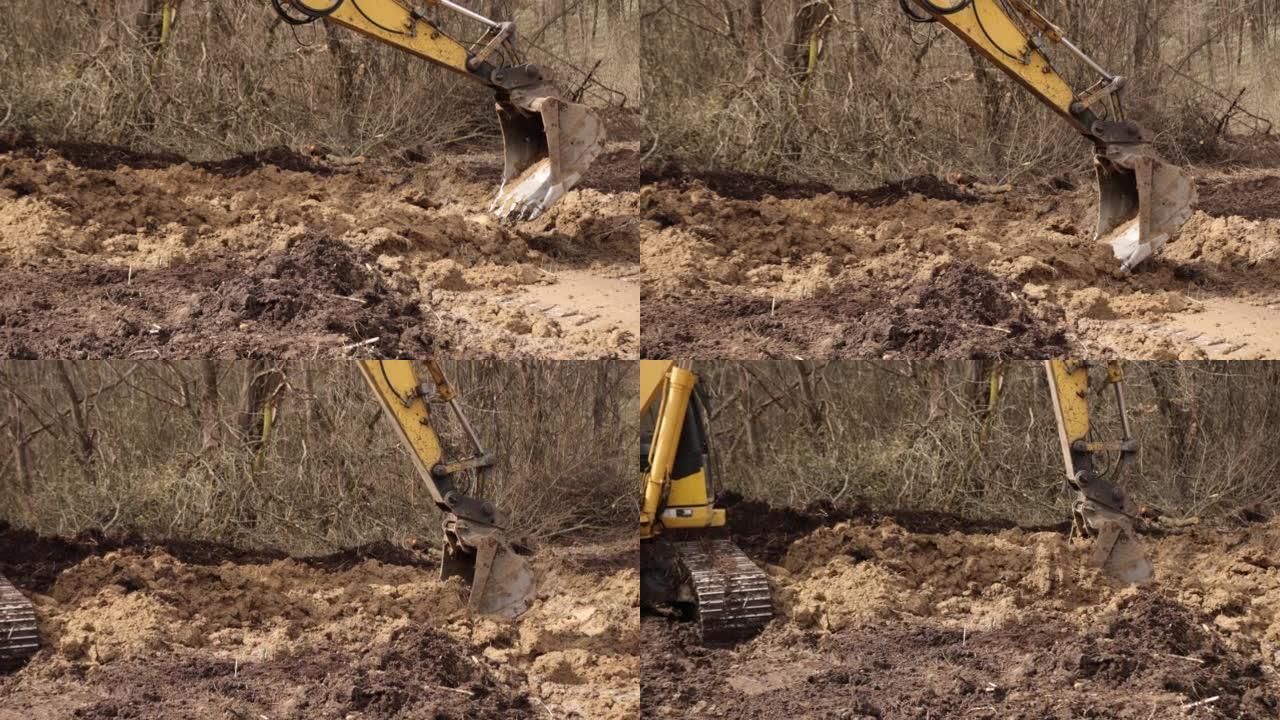履带式挖掘机。在施工现场用铲斗升降机挖土挖泥机挖泥机。挖掘机挖掘