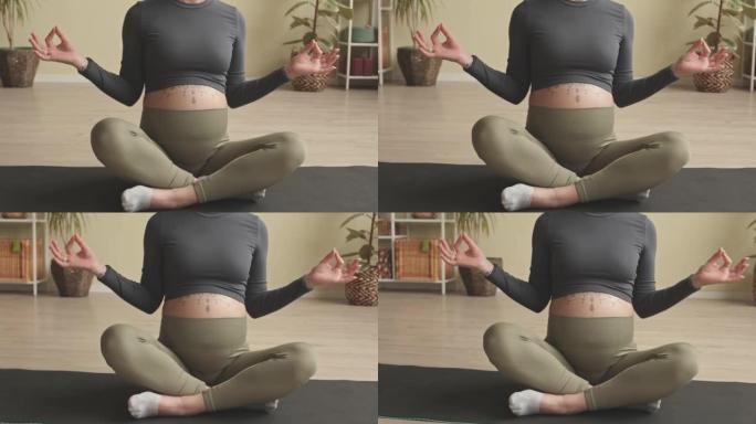 Pregnant Woman Meditating during Home Yoga Practic