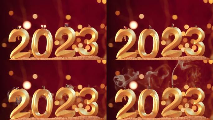 金色蜡烛形状的数字2023燃烧的火焰卡在甜点蛋糕中。花环的黄色圆光照在红色背景上。4k镜头新年快乐。
