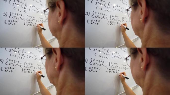 年老的老师正在白板上写方程式。