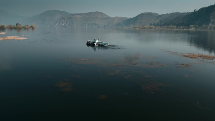 云南高原湖泊风光湖面采捞船打捞水草