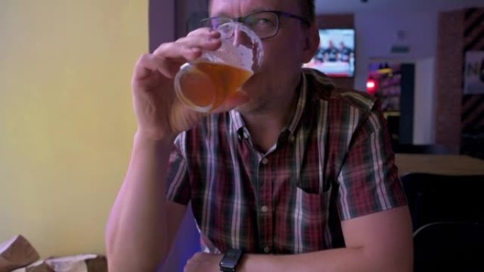 Man drinking and enjoing his beer in a bar . 4k vi
