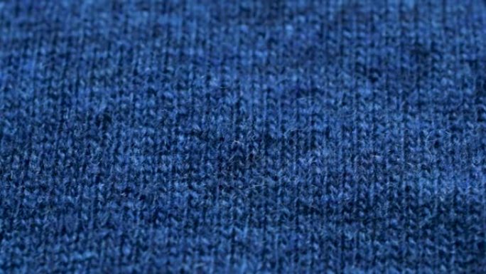 蓝色针织面料质地。特写细节毛衣面料背景。冬季时尚背景柔软羊毛纺织图案