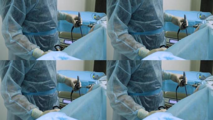 外科医生站在一件戴着无菌手套的防护服上，巧妙地对躺在其侧面的麻醉动物进行内窥镜检查。兽医学的概念。