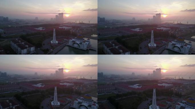 日落时雄伟的马六甲海峡清真寺的航拍镜头