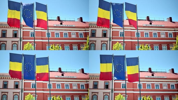罗马尼亚克卢日中心的两个国旗和一个欧盟。背景上的经典建筑