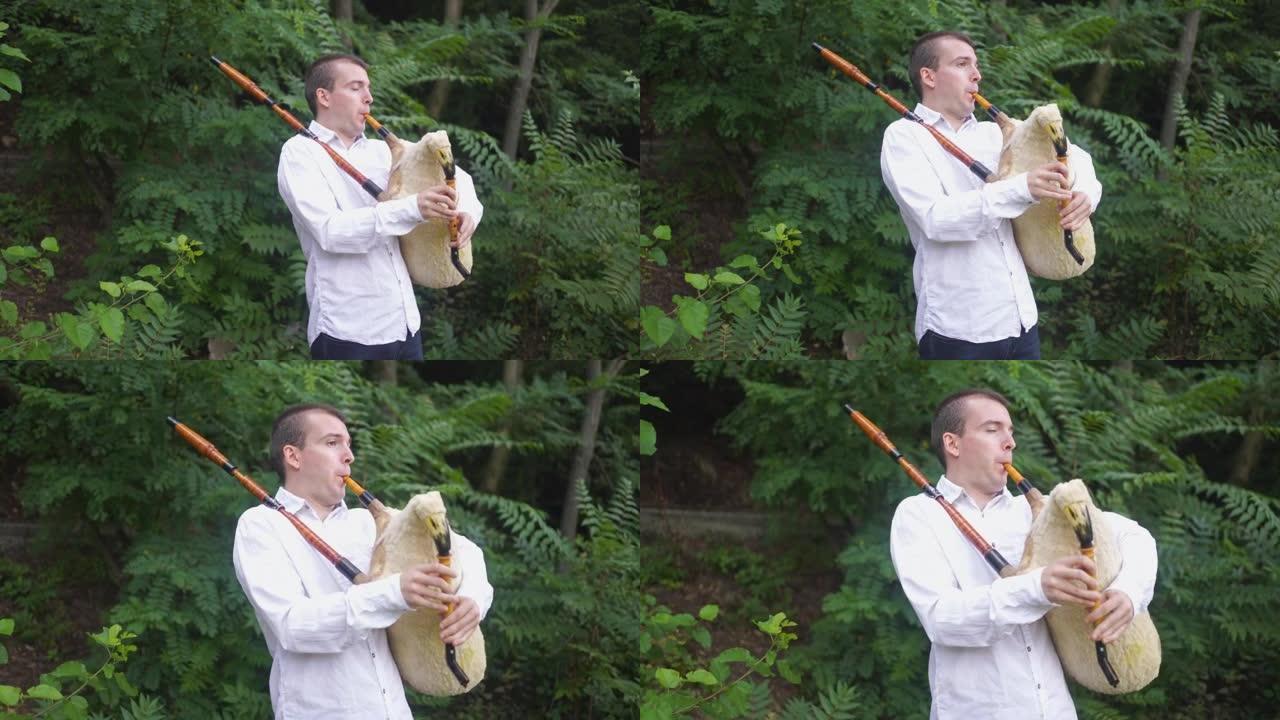 男性在玩风笛时享受山间空气、景色和宁静