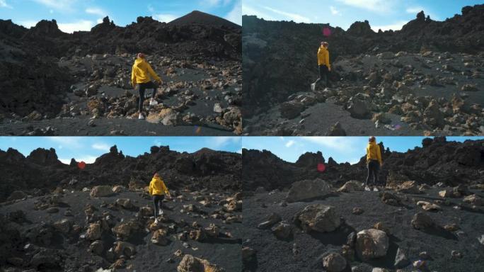 女旅行者在特内里费岛泰德国家公园的钦耶罗火山周围的熔岩田野中漫步。去任何地方。另一个星球的表面。