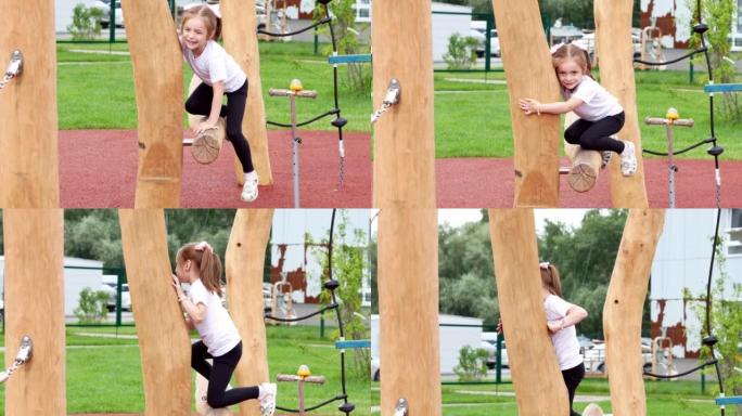 一个快乐的小女孩在现代运动场上微笑着爬上木柴。灵巧的发展