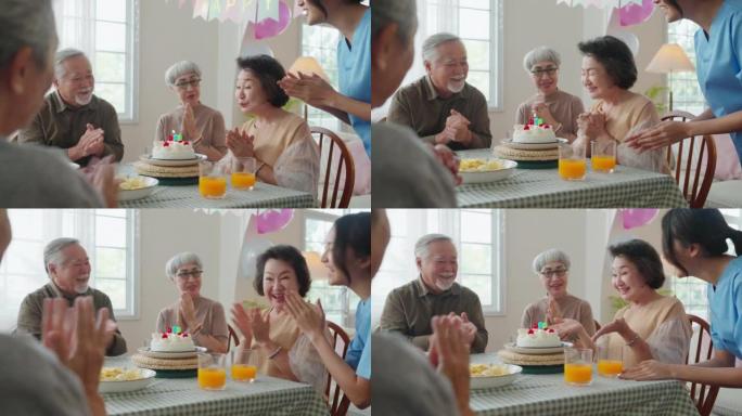 老年日托的生日派对，一群亚洲女性老年男性女性笑在养老院老年日托中心的生日朋友派对上的积极对话问候