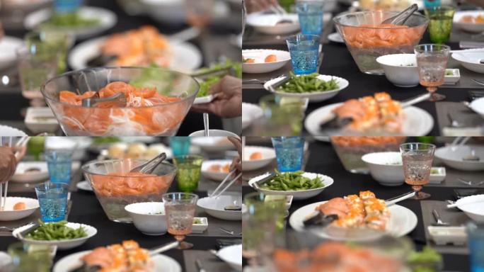 Salaryman正在高端餐厅品尝日本菜，大餐桌上配有鲑鱼，寿司，生鱼片和毛豆。