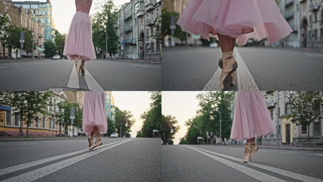 穿着足尖鞋的女人踩在城市道路上的隆隆声带上