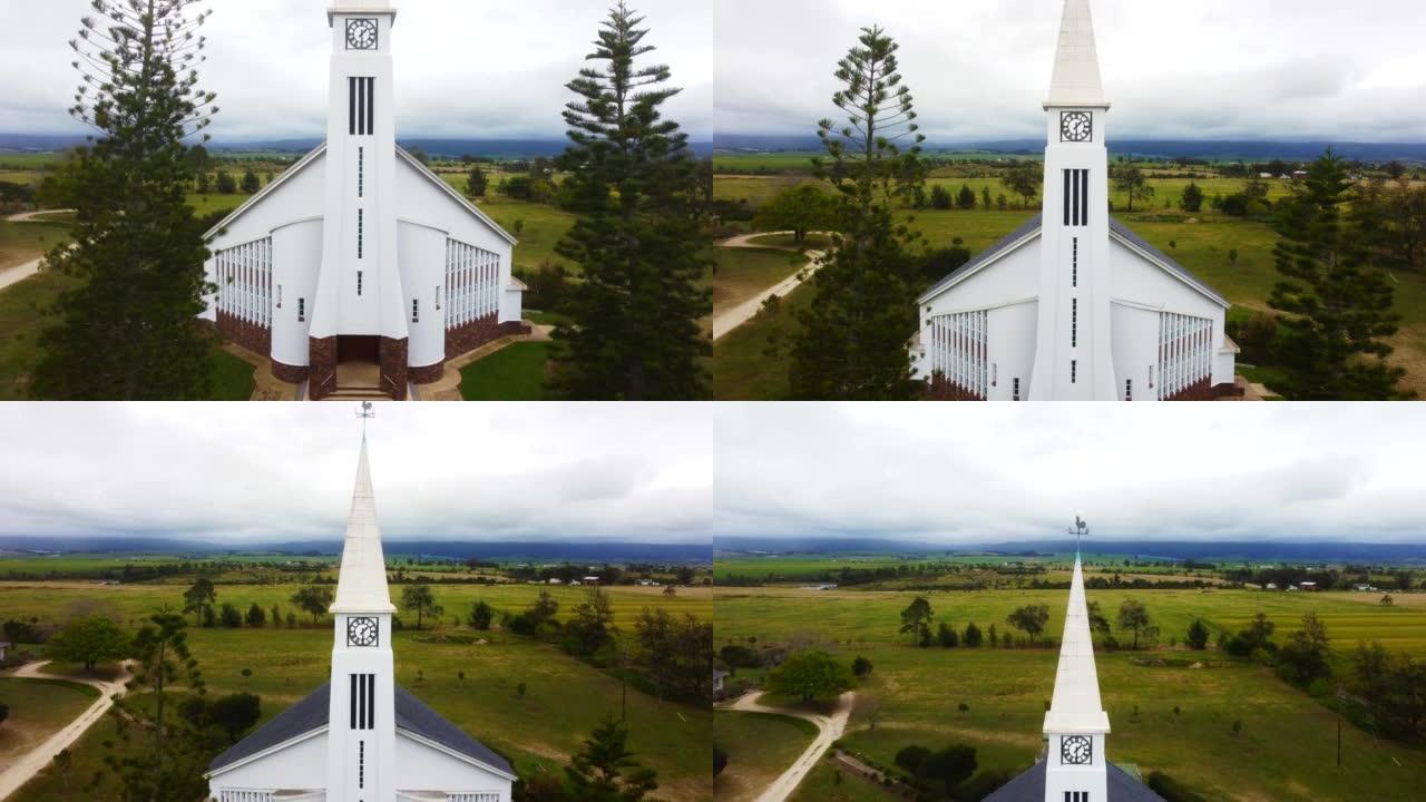 以乔治-4k分辨率在农场之间的乡村一侧拍摄白色教堂的无人机