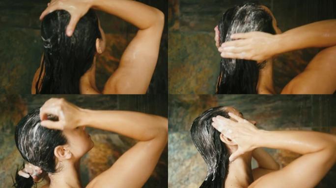 年轻女子用淋浴洗掉头发上的洗发水