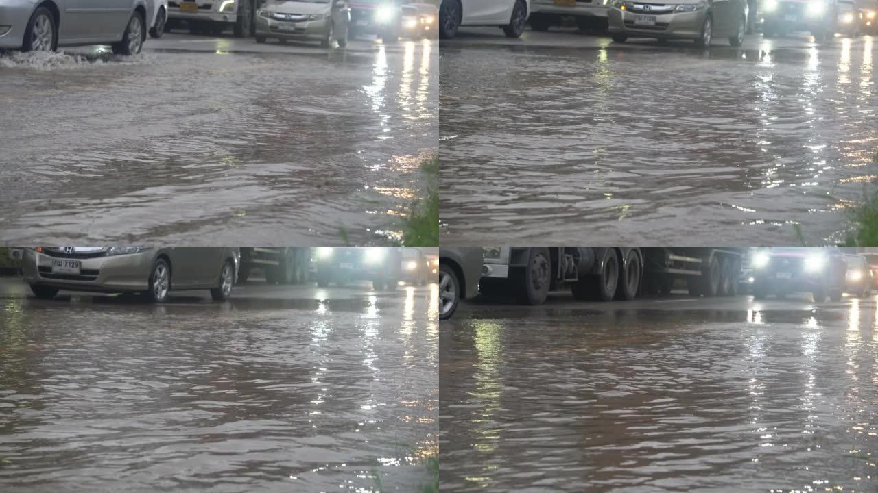 暴雨过后，汽车在洪水泛滥的道路上行驶。