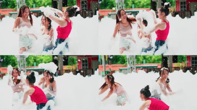 生活方式娱乐-东南亚。一群美丽的年轻女子在游泳池里享受泡沫派对