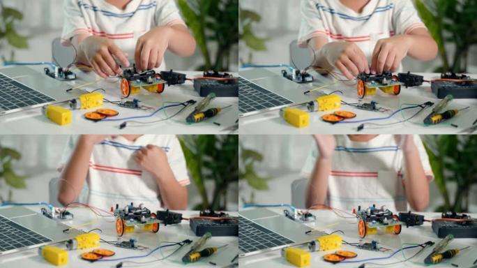 亚洲小男孩拼装板进入Arduino机器人汽车作业